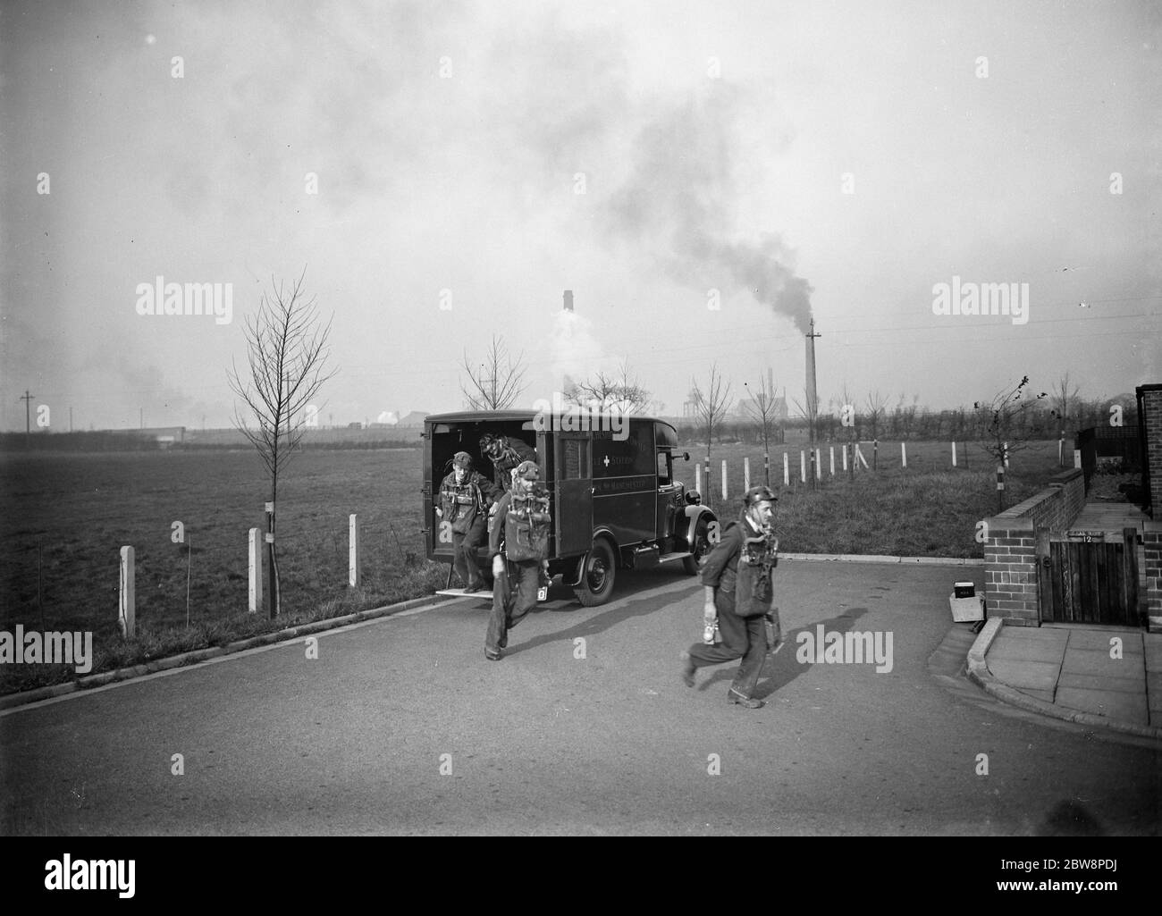 Men from the Lancashire Mine Rescue Centre wearing breathing apparatus , disembark from their truck . 1937 . Stock Photo