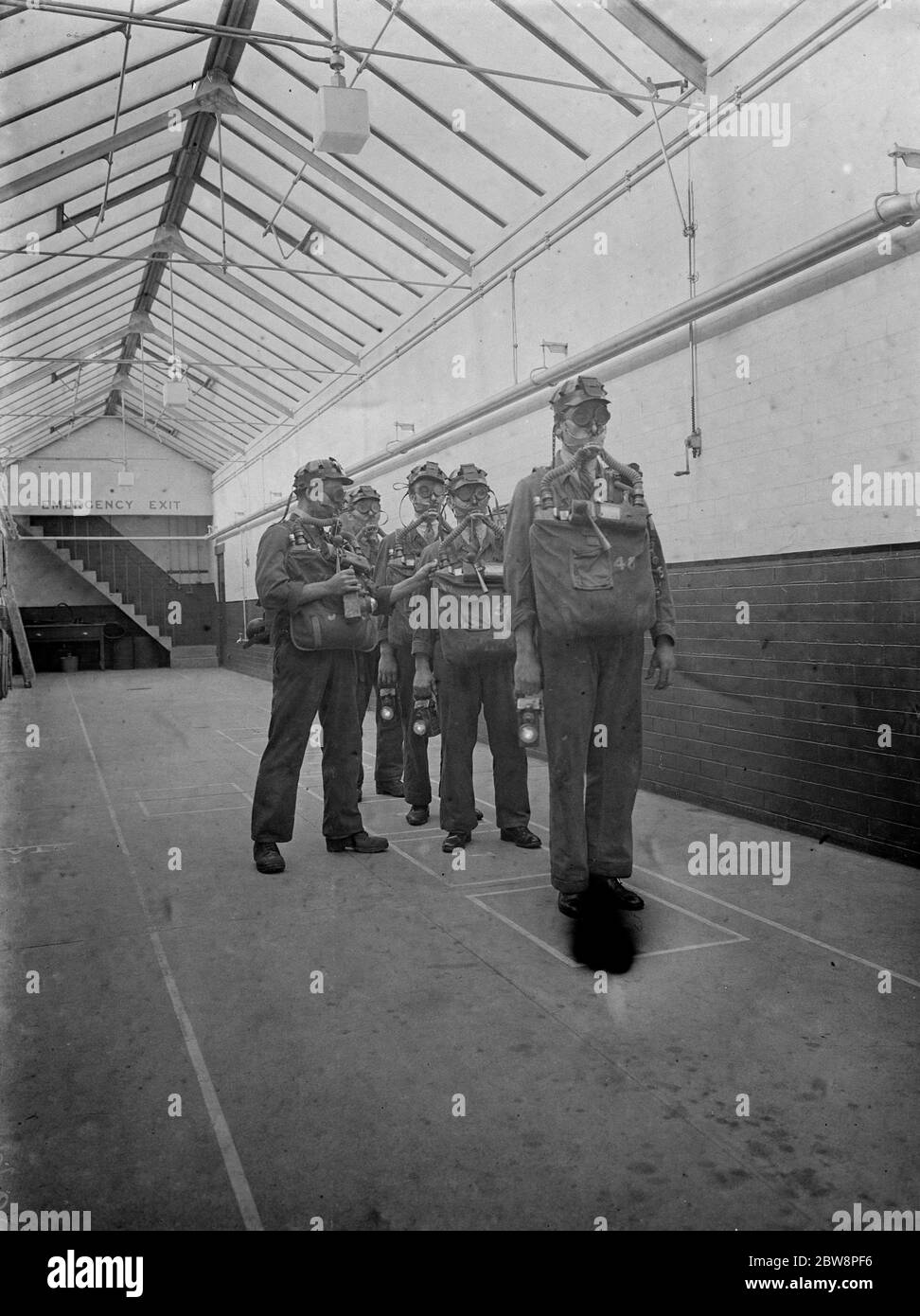 Men from the Lancashire Mine Rescue Centre check each others equipment . 1937 . Stock Photo