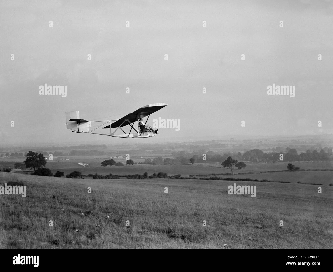 A Cessna CG-2 Glider is flown by its pilot . 1936 . Stock Photo