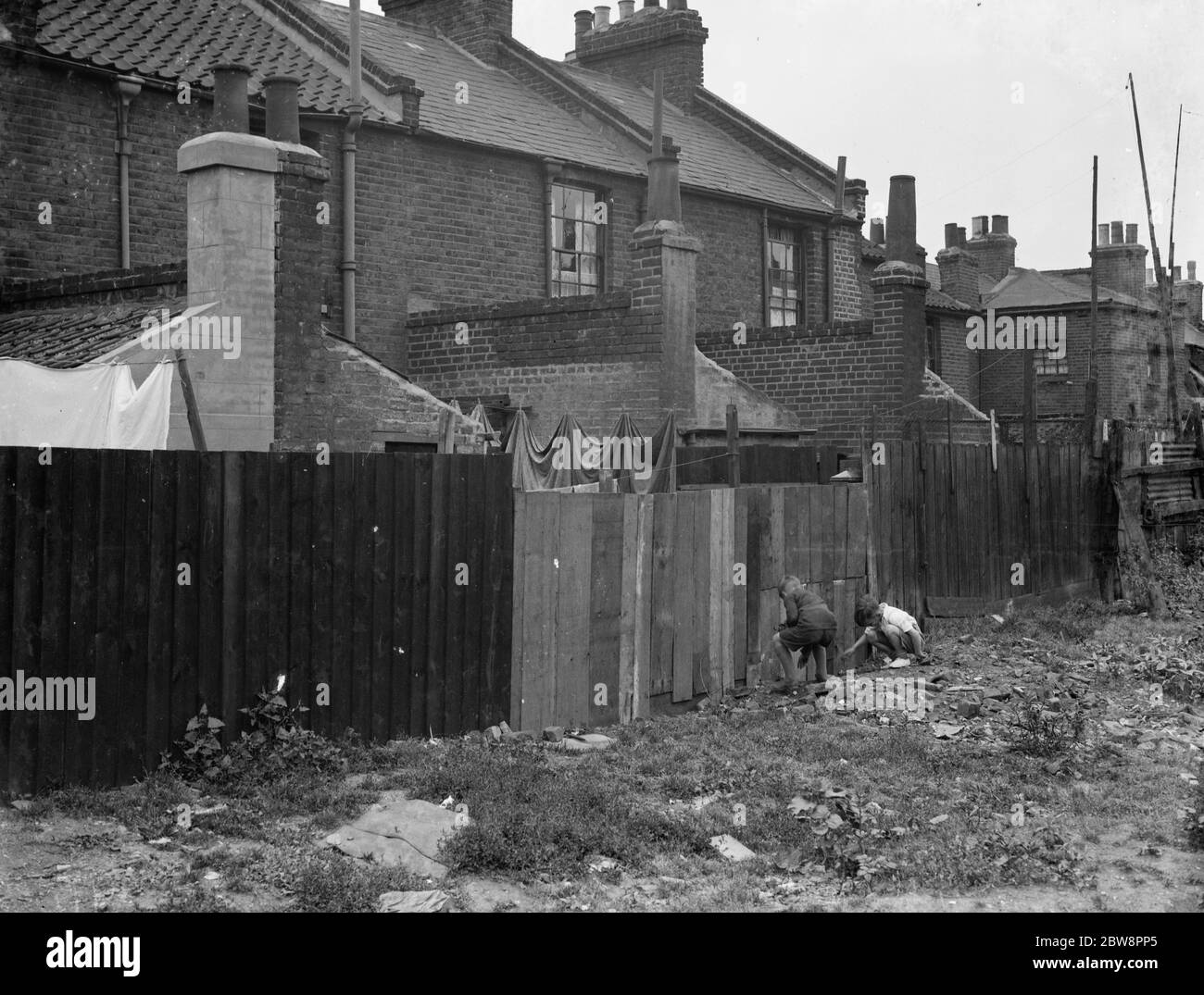 An external view of a row of houses and their gardens . 1938 . Stock Photo