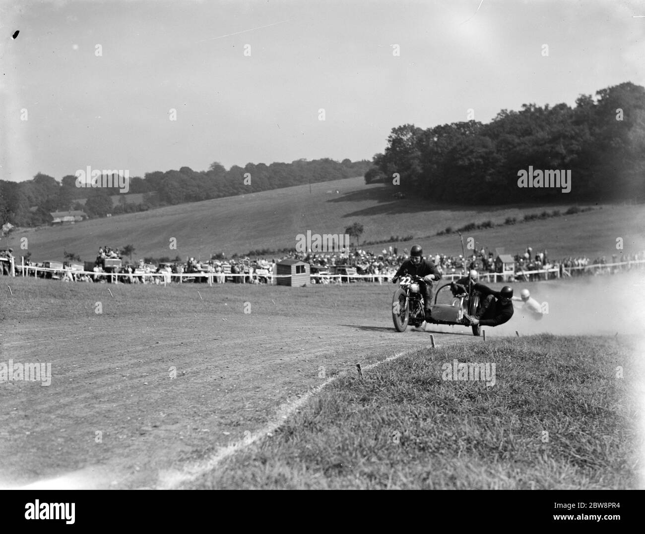 Motorcycling races at Brands Hatch . Two of the side car bikes jostle for position on a corner during the race . 1936 Stock Photo
