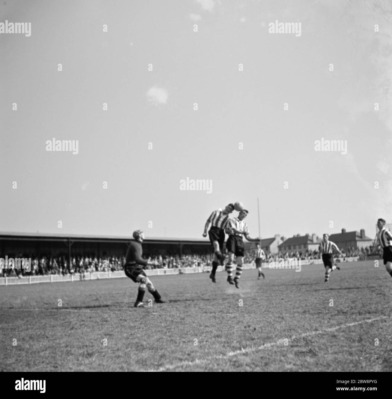 Dartford vs. Newport County reserves - Southern League - 29/08/36 Newport County Association Football Club versus Dartford football club . Two players compete fo the ball while the goalie watches on . 1936 Stock Photo