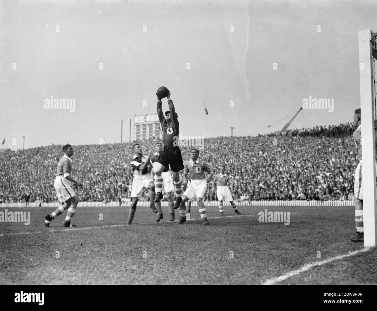 Newport County Association Football Club versus Millwall Football Club . The Millwall keeper plucks the ball from the air . 1936 Stock Photo