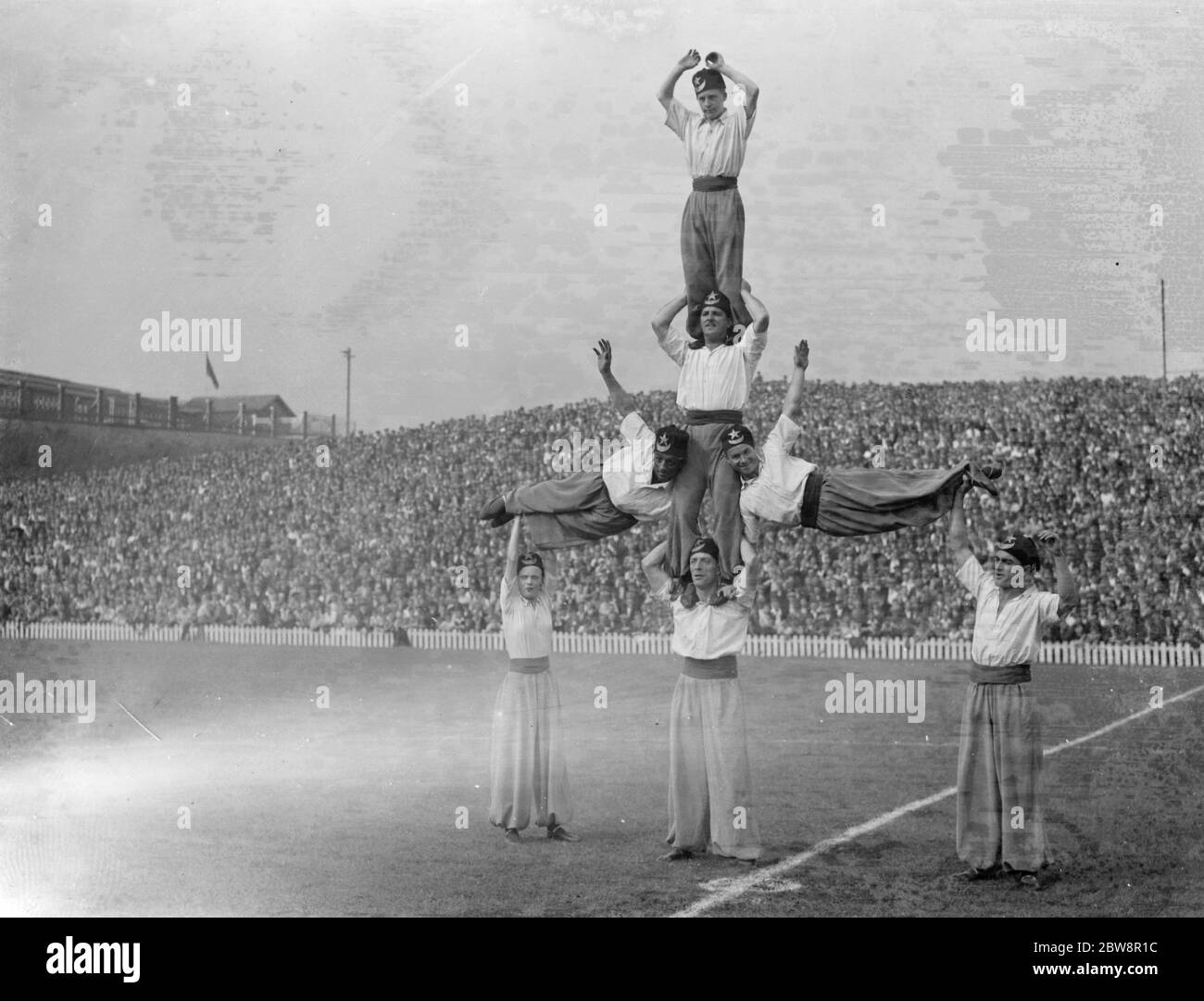 Newport County Association Football Club versus Millwall Football Club . Half time entertainment by a group of acrobats in a human pyramid . 1936 Stock Photo