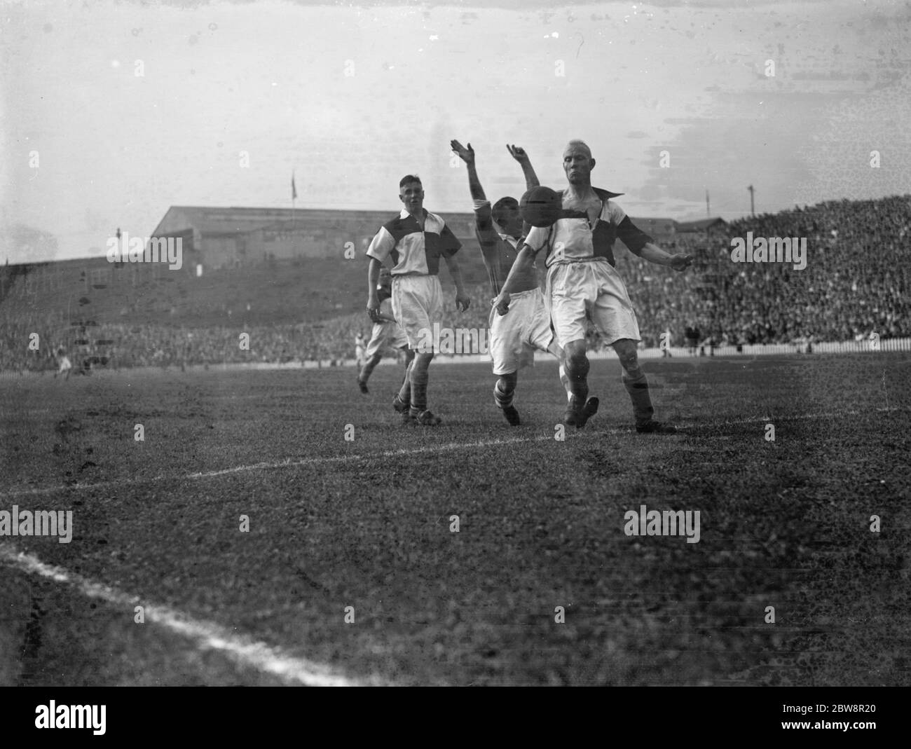 Newport County Association Football Club versus Millwall Football Club . Players compete for the ball . 1936 Stock Photo