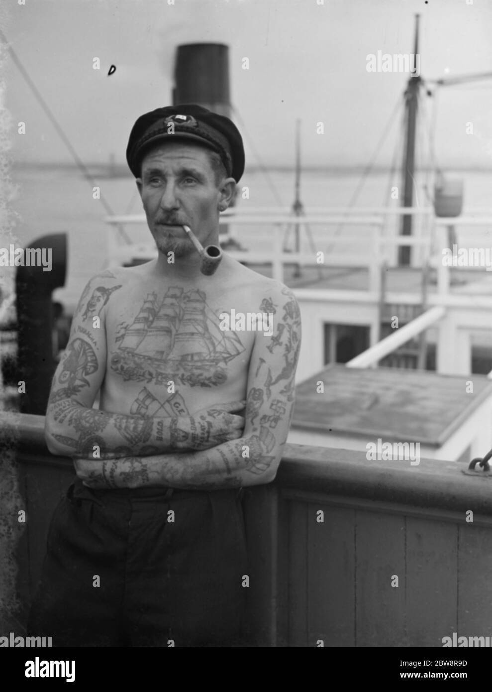Patrick Rust the second officer on the P 80 showing his tattooed chest and arms . 1938 Stock Photo