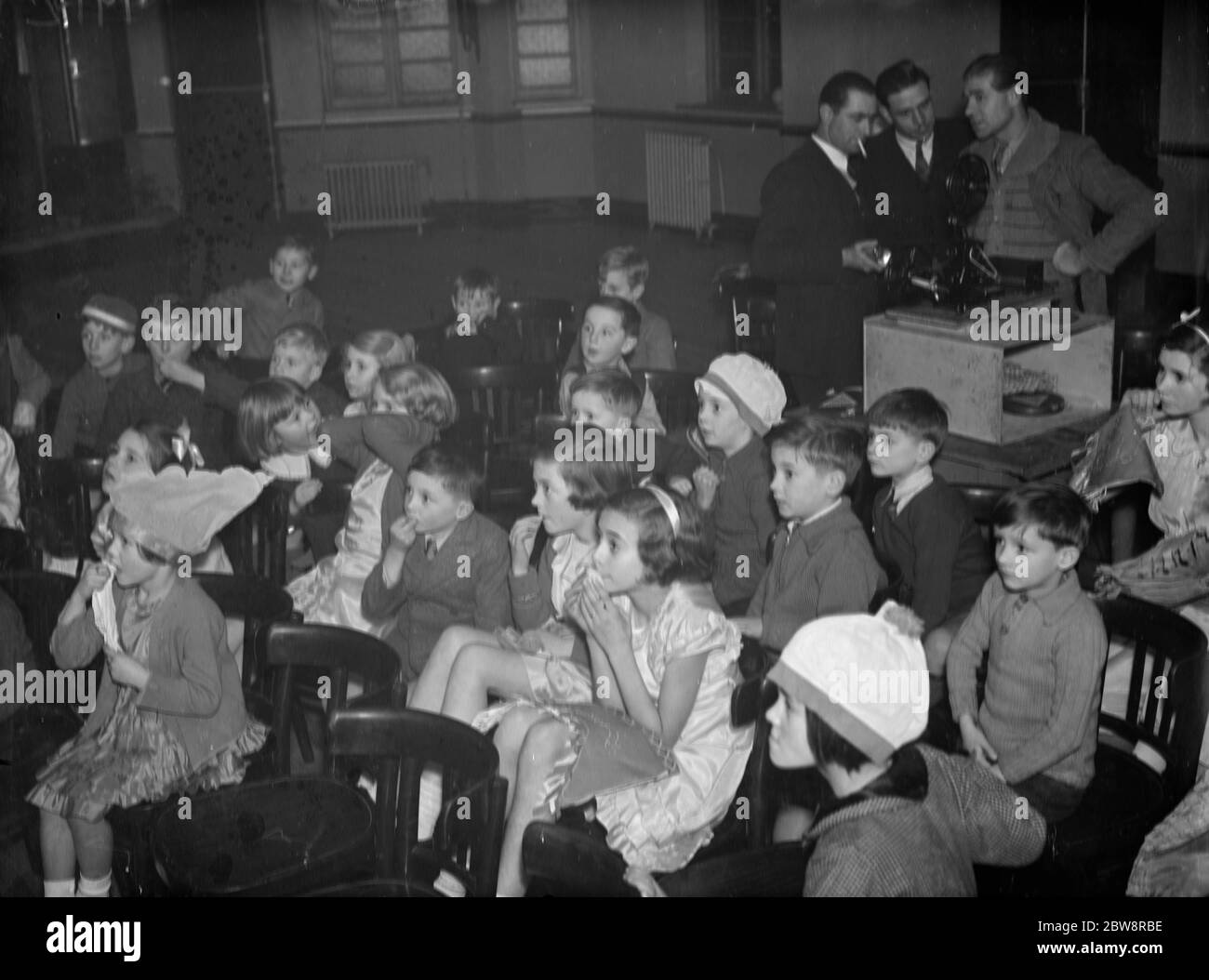 The Ideal Sports Club hold a film show for the local children . 1938 Stock Photo
