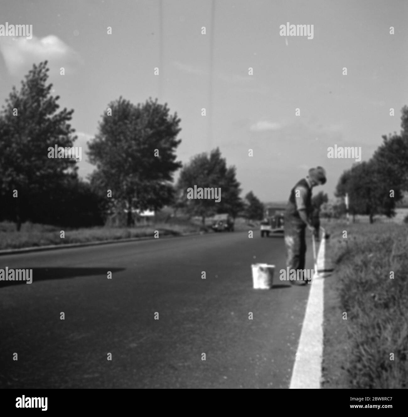 Men painting the white line marking on a roads . 1936 Stock Photo