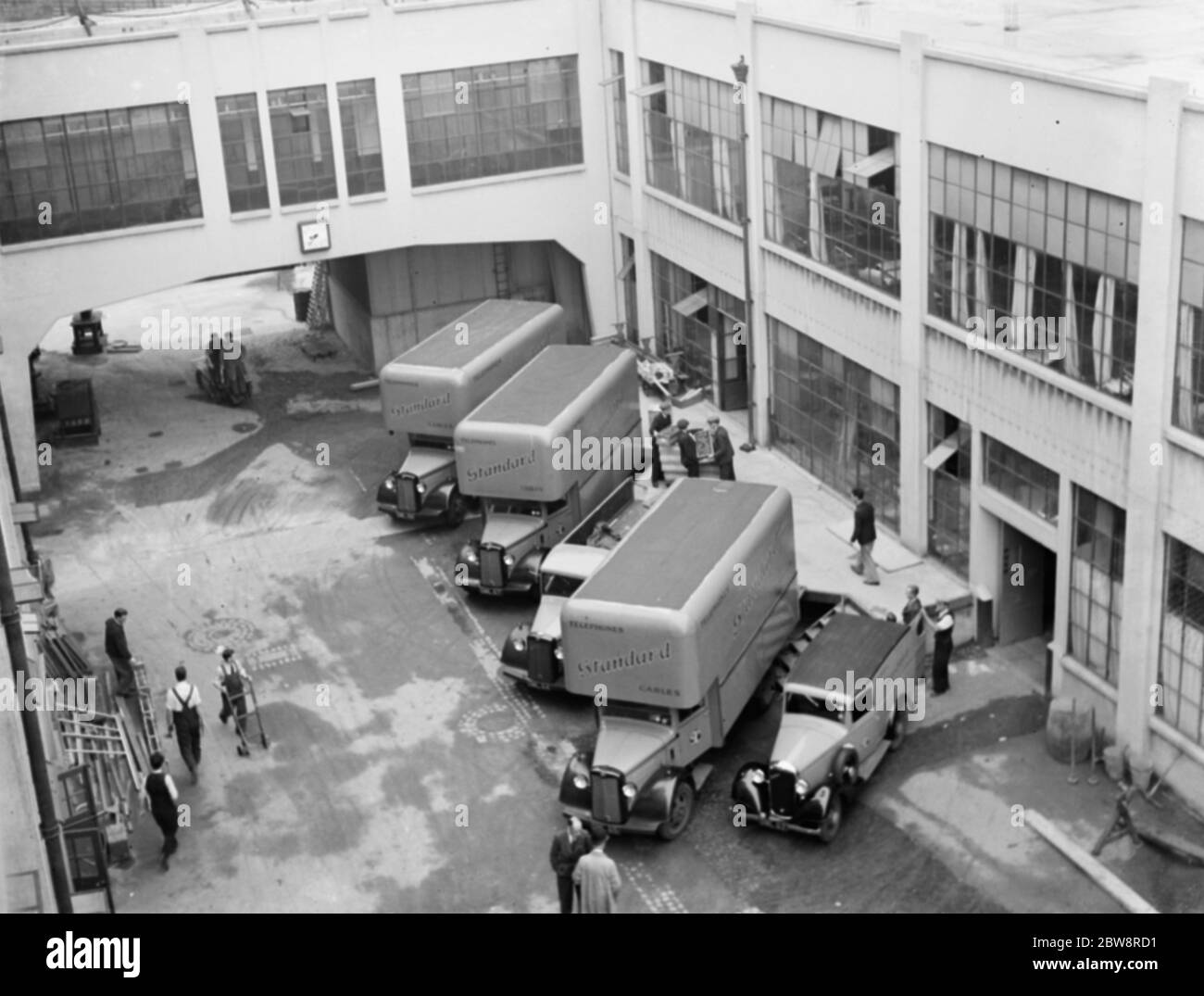 Bedford trucks belonging to the Standard Telephone and Cables Company Ltd , being loaded up outside their factory . 1936 . Stock Photo