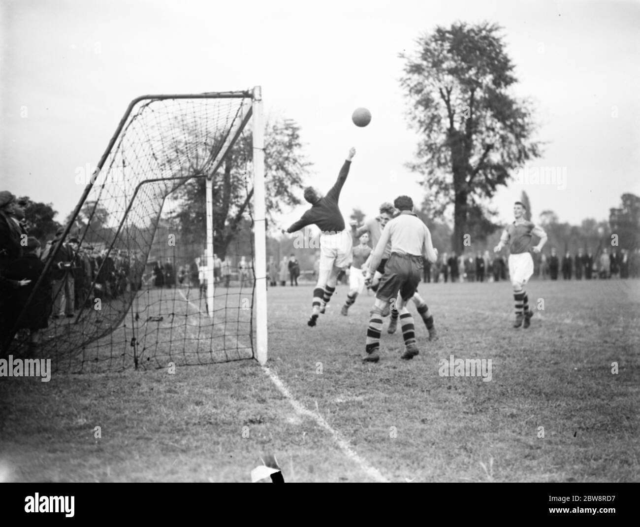 A football match in Swanley , Kent . Goalkeeper reaches for the ball . 1936 Stock Photo