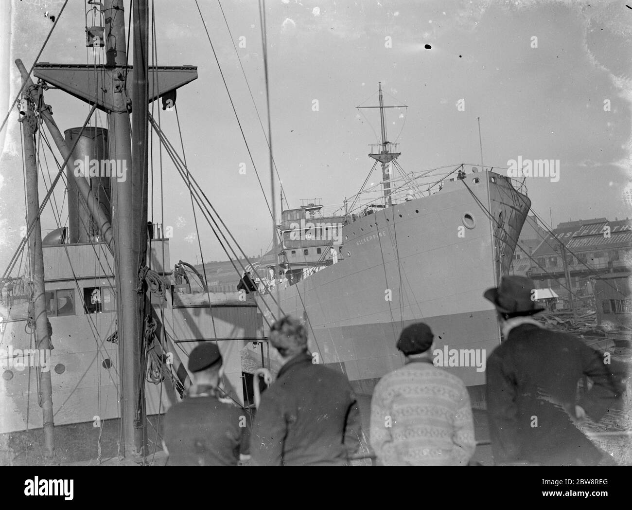 Viewing the merchant ship the  Silver Pine  from the deck of the steamer the ' SS Eston ' . 1935 Stock Photo