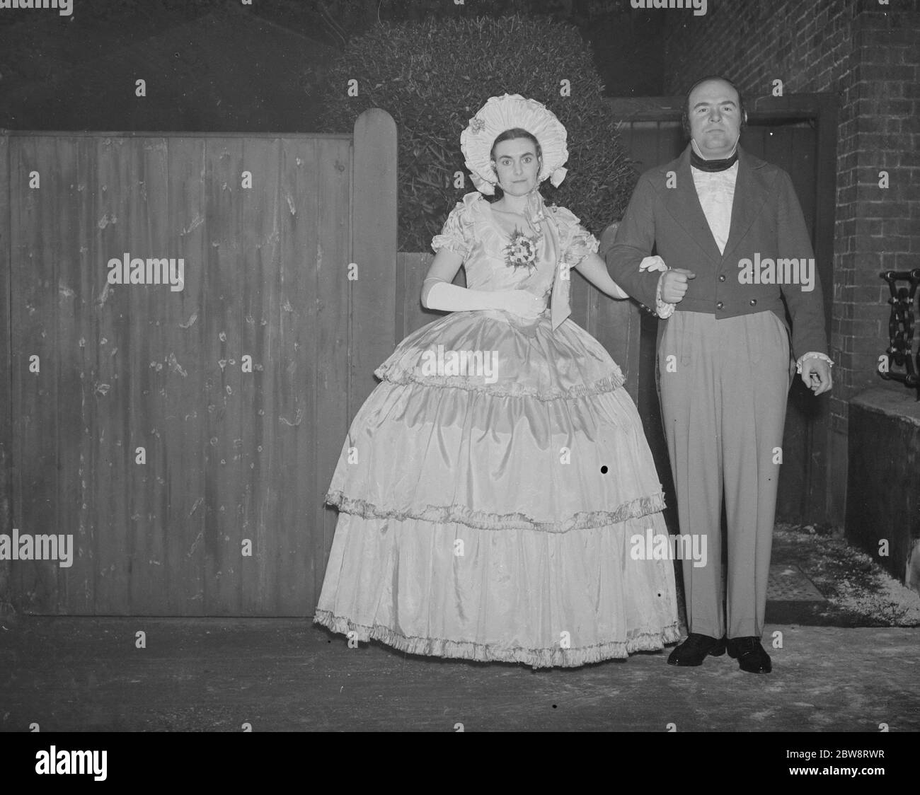 Photographer , Mr John Topham with Miss Haken , dressed in Victorian costume . 1938 Stock Photo