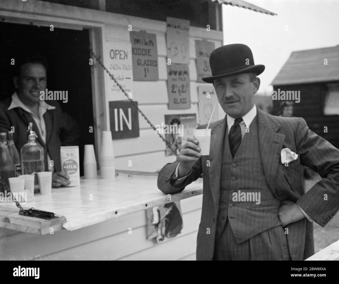 Whitbread ' s hop farm in Belting , Kent . A gentleman enjoys a cup of milk at the onsite milk bar . 1938 Stock Photo