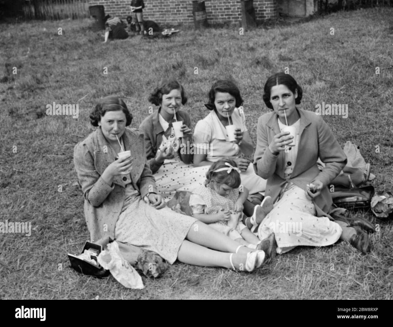 Whitbread ' s hop farm in Belting , Kent . Some ladys are enjoying a cup of milk from the onsite milk bar . 1938 Stock Photo