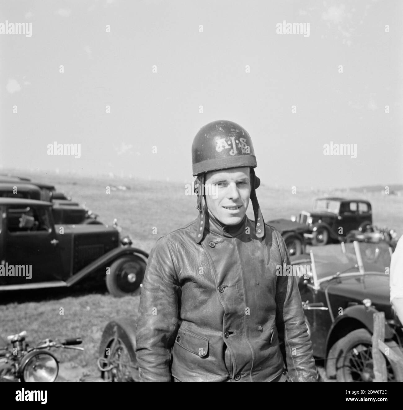 Motorcycle racing at Brands Hatch , Kent . A rider poses for a photo
