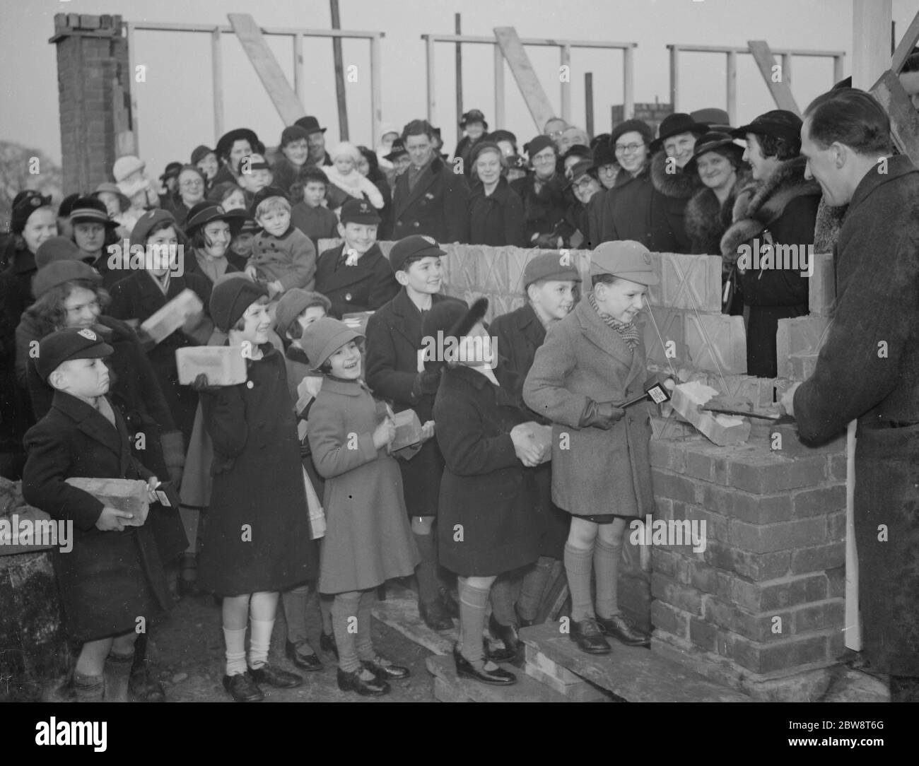 Children laying the foundation bricks at the building of the new Baptist Hall at Sidcup , Kent . 1938 Stock Photo