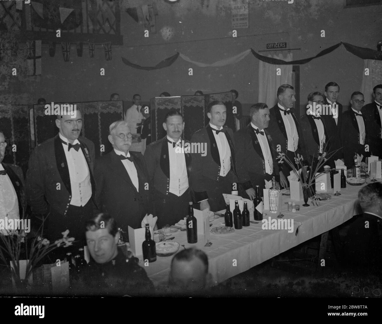 Dartford Territorial Army dinner . On the table , from left to right ; Major EB Loveless , Court , W Trivett , Lt. Colonel HS Brown, MC , Captain T Kenyon , Major AS Fuller , Dr FC Knight , Captain HA Conn and Lieutenant Chuter . 1938 Stock Photo