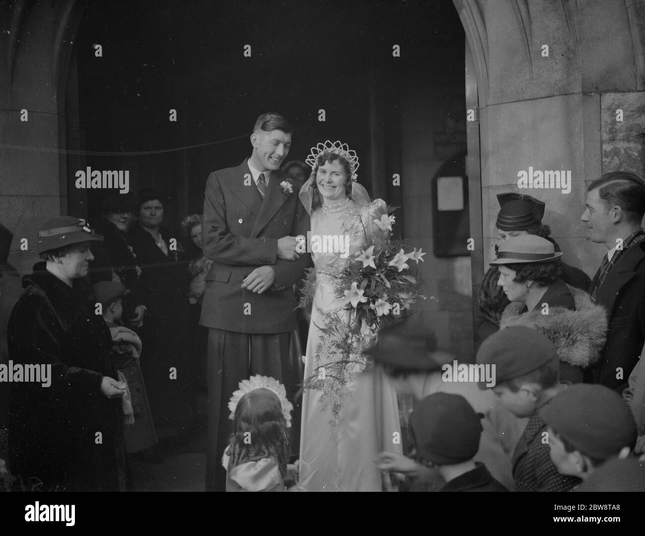 The wedding of Mr A Gower and Miss D Barnett . The bride and groom leave the church . 19 February 1938 Stock Photo