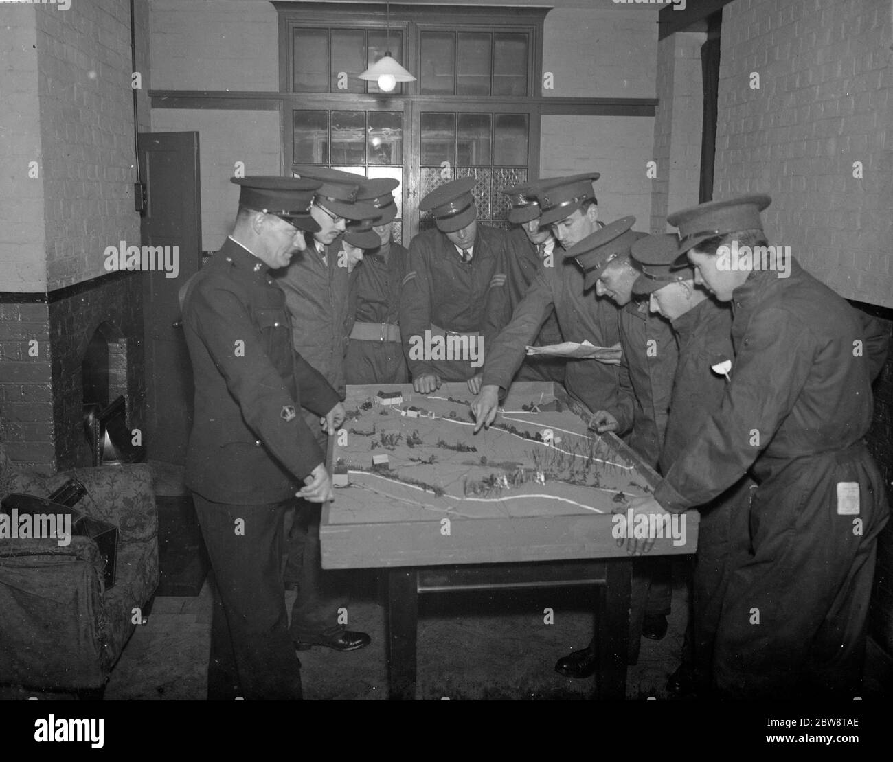 Army officers using a model of terrain for instruction on tactics at the Dartford Territorial Army camp . 1938 Stock Photo