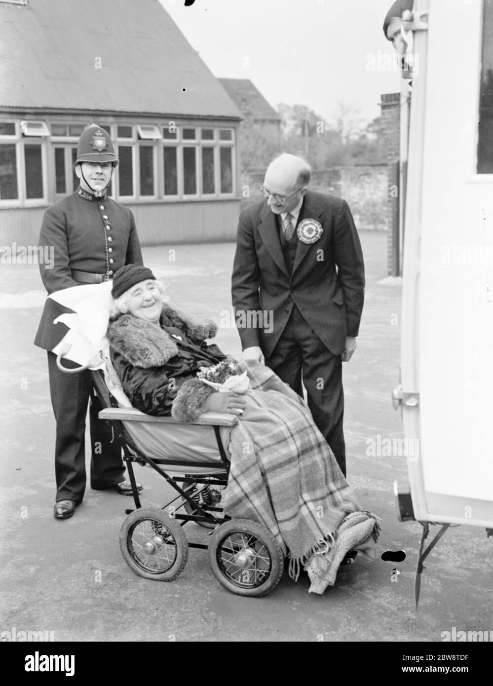 Election day : Mrs May , Countess of Limerick chats to the Conservative Party candidate for the Dartford by - election , Mr Geoffrey Mitchell as P C Sinclair PC 356 stands by . 1938 Stock Photo