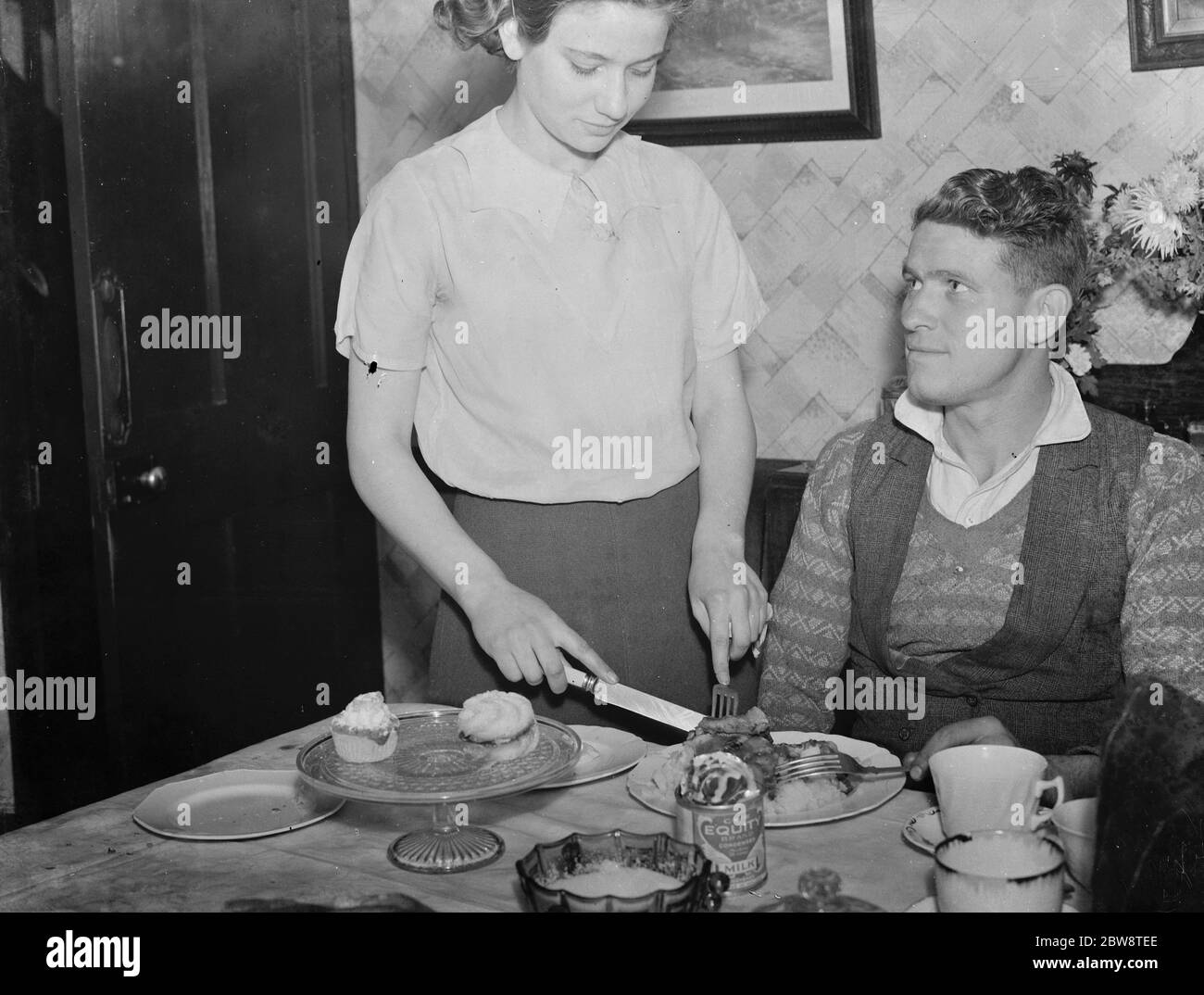 Mr D J Harris and Miss Harris , at the table . 1938 Stock Photo