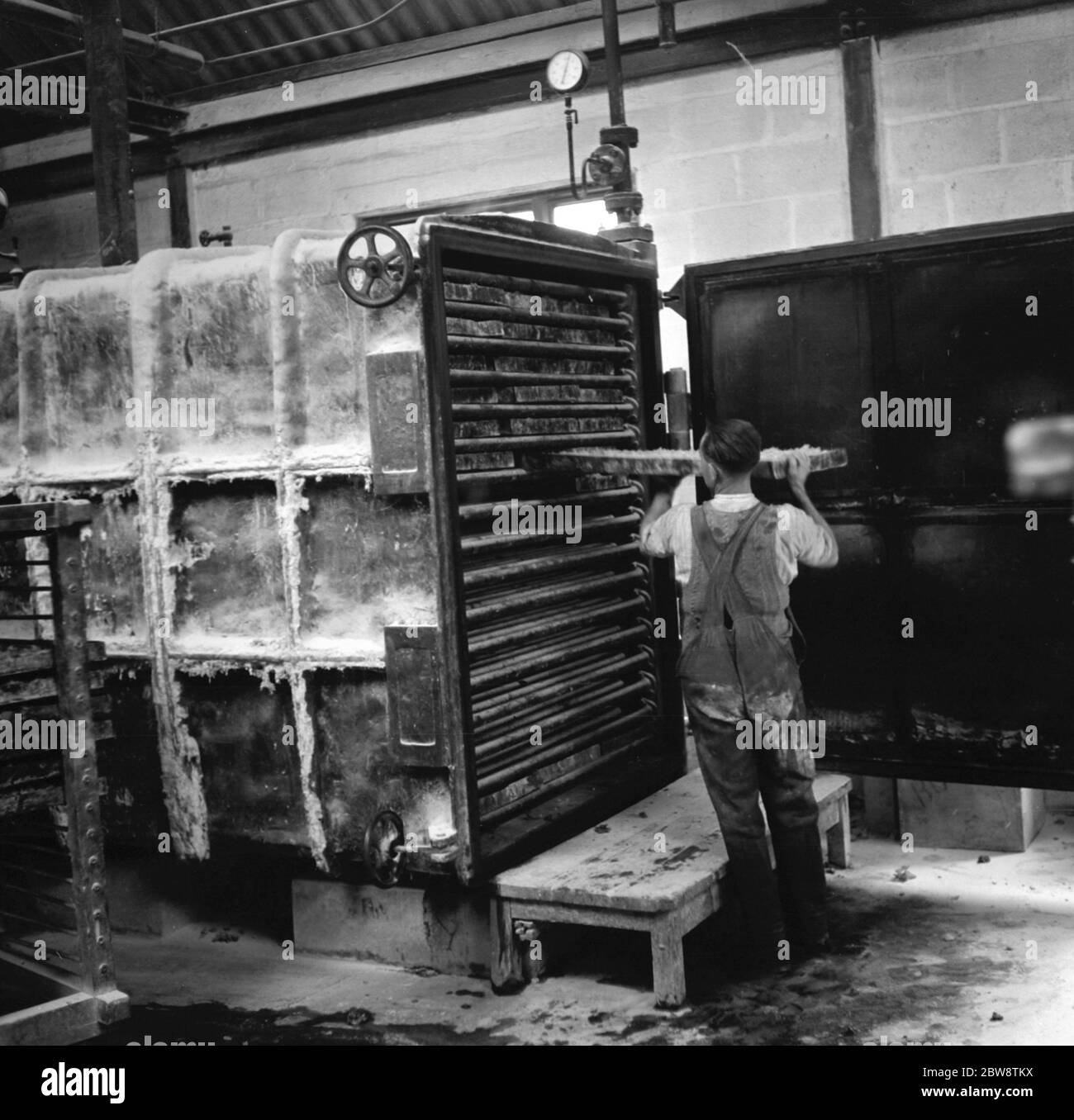 Rubber is put into ovens to bake . 1936 . Stock Photo