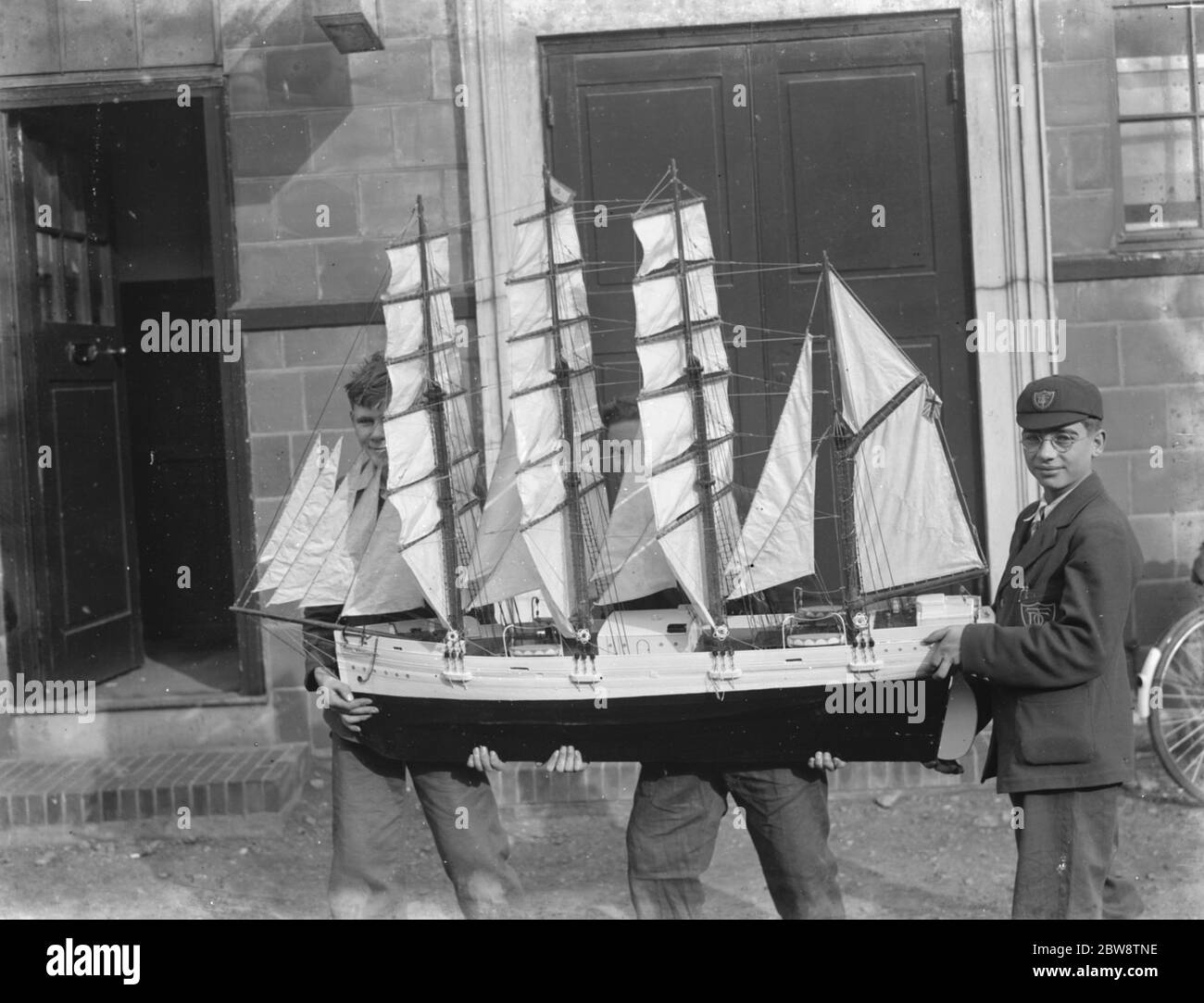Boys hold up a model sailing ship at the handicraft exhibition in Dartford , Kent . 1936 Stock Photo
