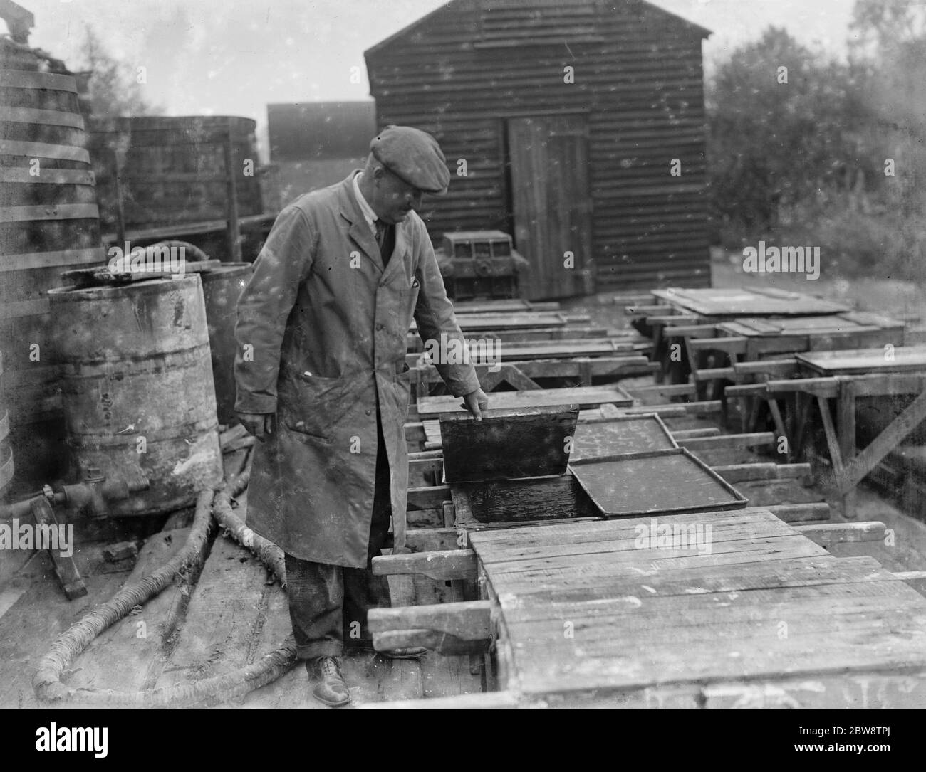 Part of the process of pouring sulphuric acid onto cadmium bars at the Tyke and Kings Chemical Works . 1936 Stock Photo