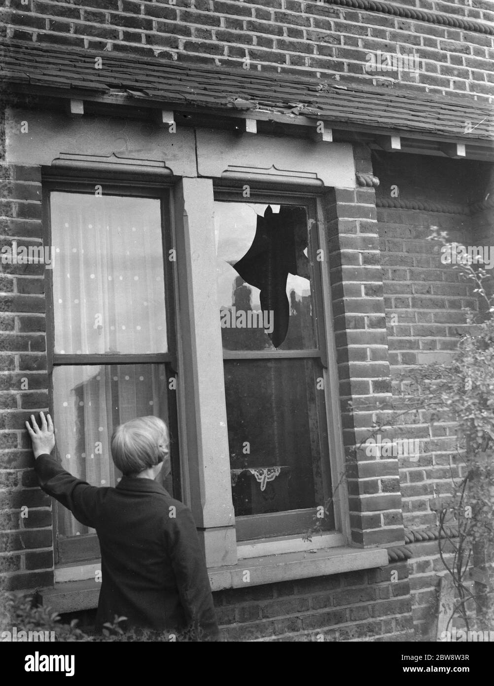Storm damage : a broken window . 1938 Stock Photo