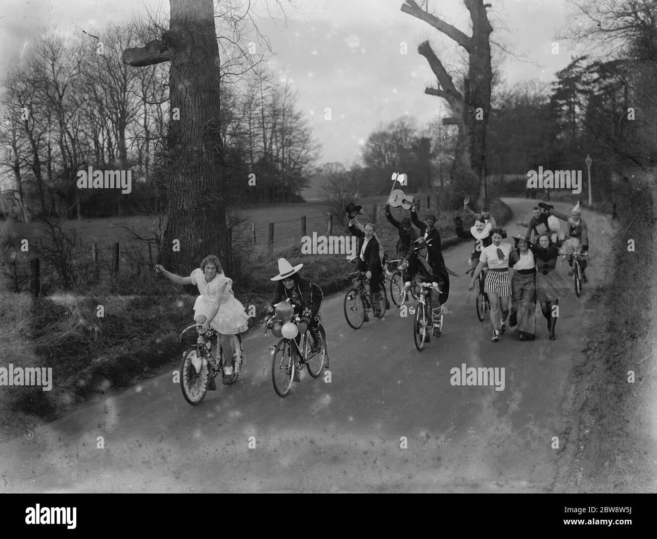 Sidcup Touring Clubs : fancy dress . Riding bicycles down the road . 1936 . Stock Photo