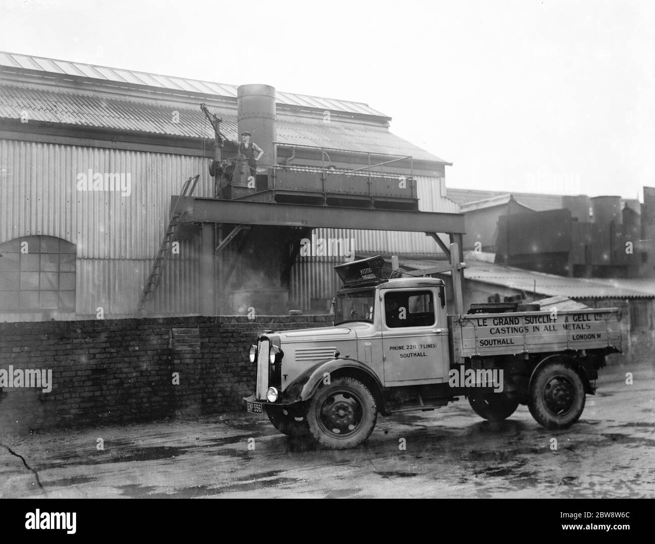 Bedford lorries belonging to Le Grand Sutcliff and Gell Ltd from Southall Londond , loading up at a freight station . 1936 . Stock Photo