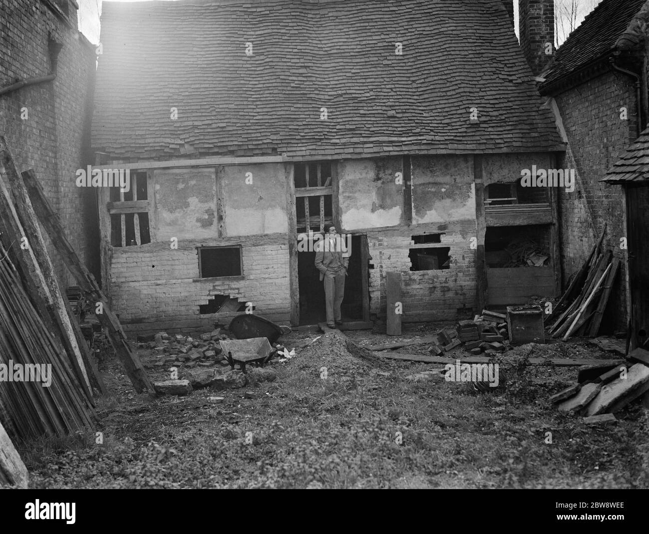 Mr Greenfield at an old dilapidated cottage , wich is to be used as a museum in Eynsford , Kent . 12 December 1938 Stock Photo