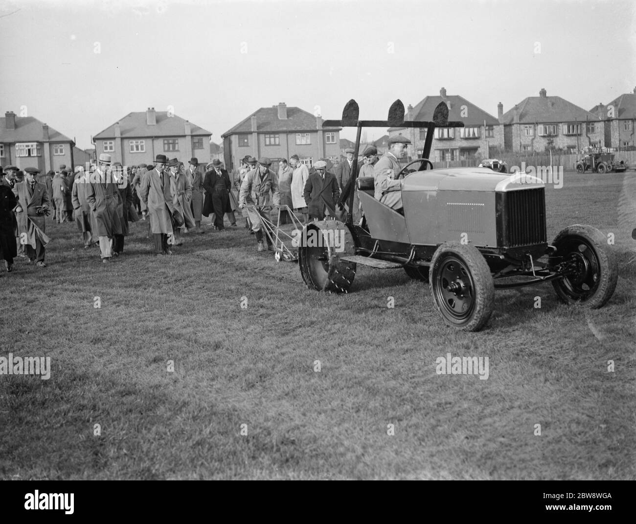 Pattisson tractor demonstration . A tractor with a turf cutter attached . 1938 Stock Photo