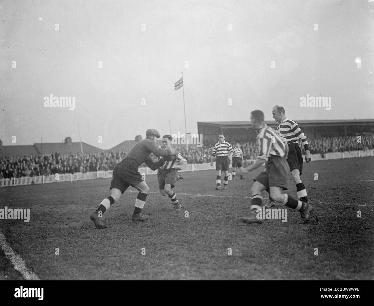 Dartford versus Darlington football match . Action in front of the goal , the goalkeeper makes a save . 1937 Stock Photo