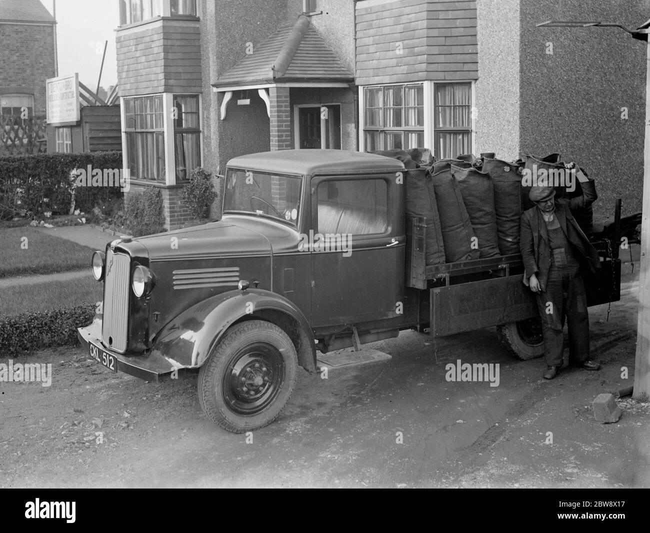 Coal delivery by one of the coal vans from H Salmon , Coal and Coke Merchants in Orpington , Kent . 1936 . Stock Photo