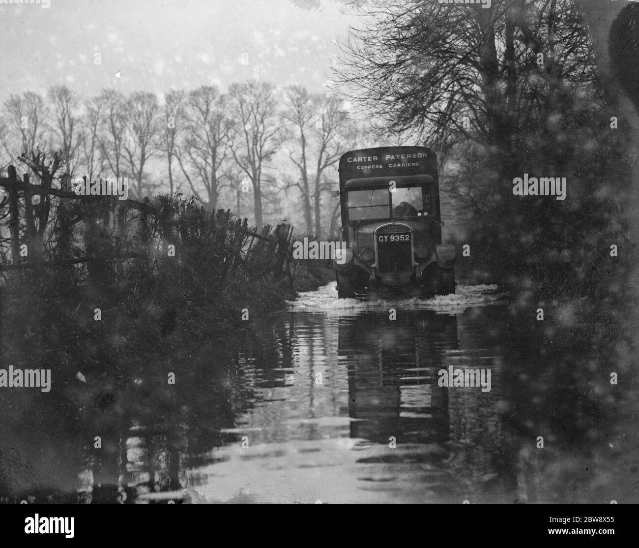 A Carter Paterson express carrier lorry driving through the flooded roads near Darenth , Kent . 1936 Stock Photo