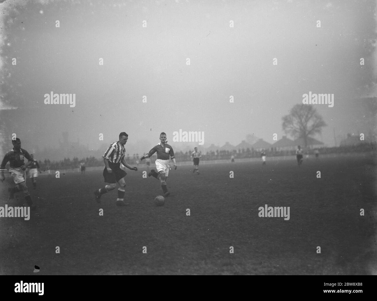 Dartford football club versus Peterborough United Football Club . Two players compete for the ball . 1936 Stock Photo