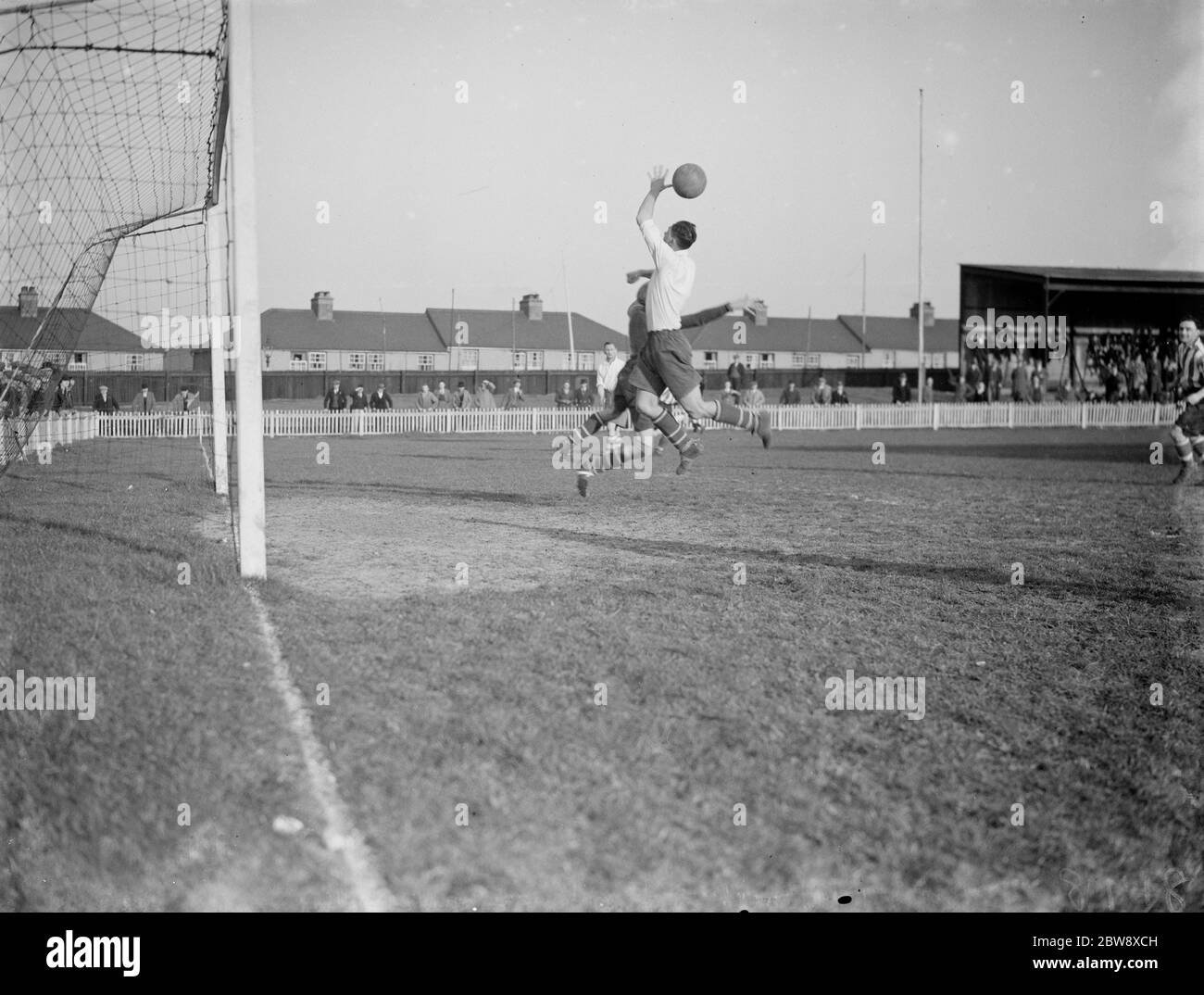 Dartford vs. Guildford City - Southern League Mid-week section - 05/03/38 The goal keeper and an attacker compete for an aerial ball . 1938 Stock Photo