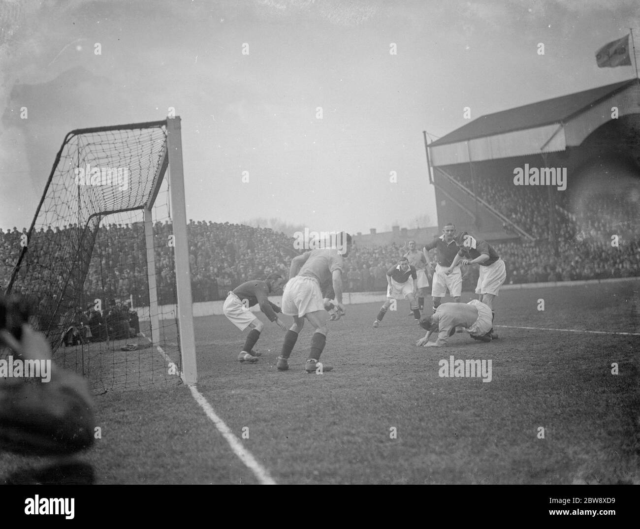 Nottingham Forest Football Club versus Charlton Athletic football club . Two players compete for the ball in front of goal . 10 April 1936 Stock Photo