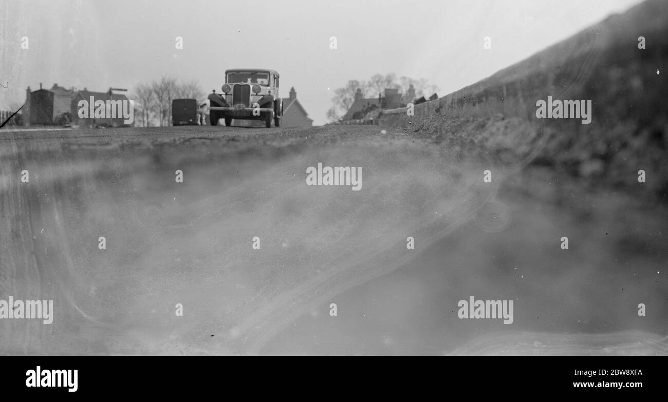 Workmen lay the foundations for road banking along the edges of the road in Farningham . 1936 Stock Photo