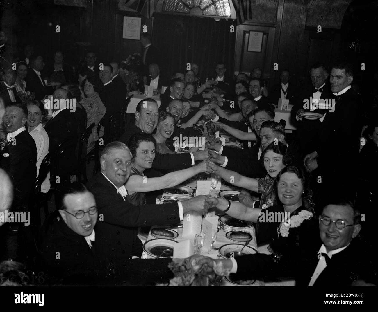 The ladies night at the Eltham Rotarians Club . Handshakes over the table . 1938 Stock Photo Alamy