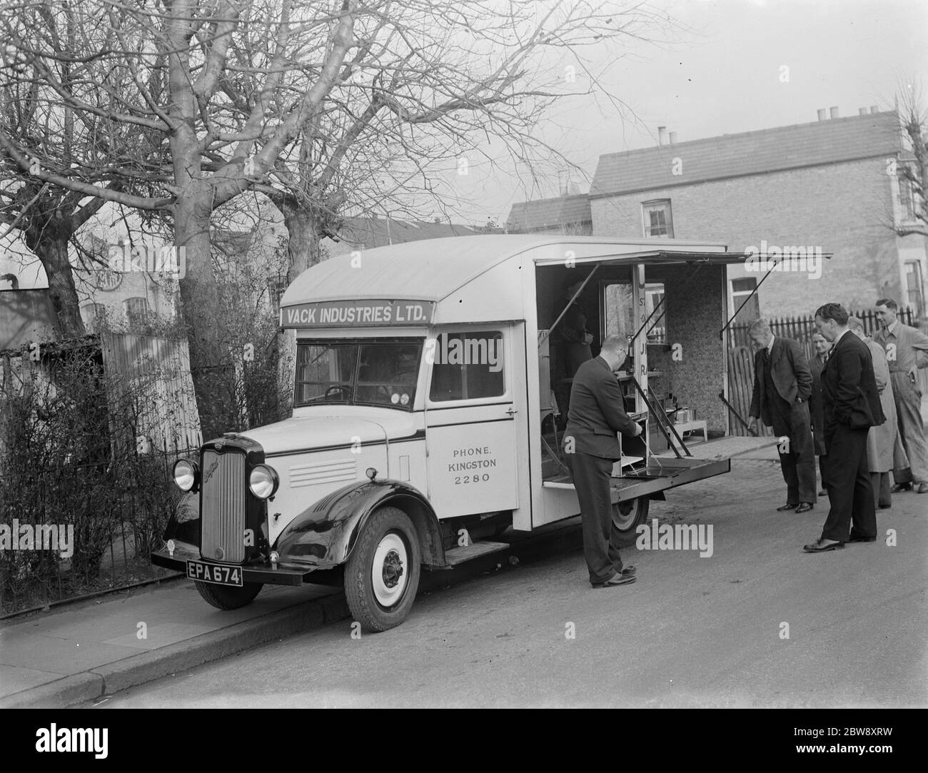 A Bedford truck belonging to Vack Industries Ltd from Kingston upon Thames , London . The truck has been converted into a mobile showroom for their oil burning apparatus. The side of the lorry opens out to reveal the domestic appliances . 1937 . Stock Photo