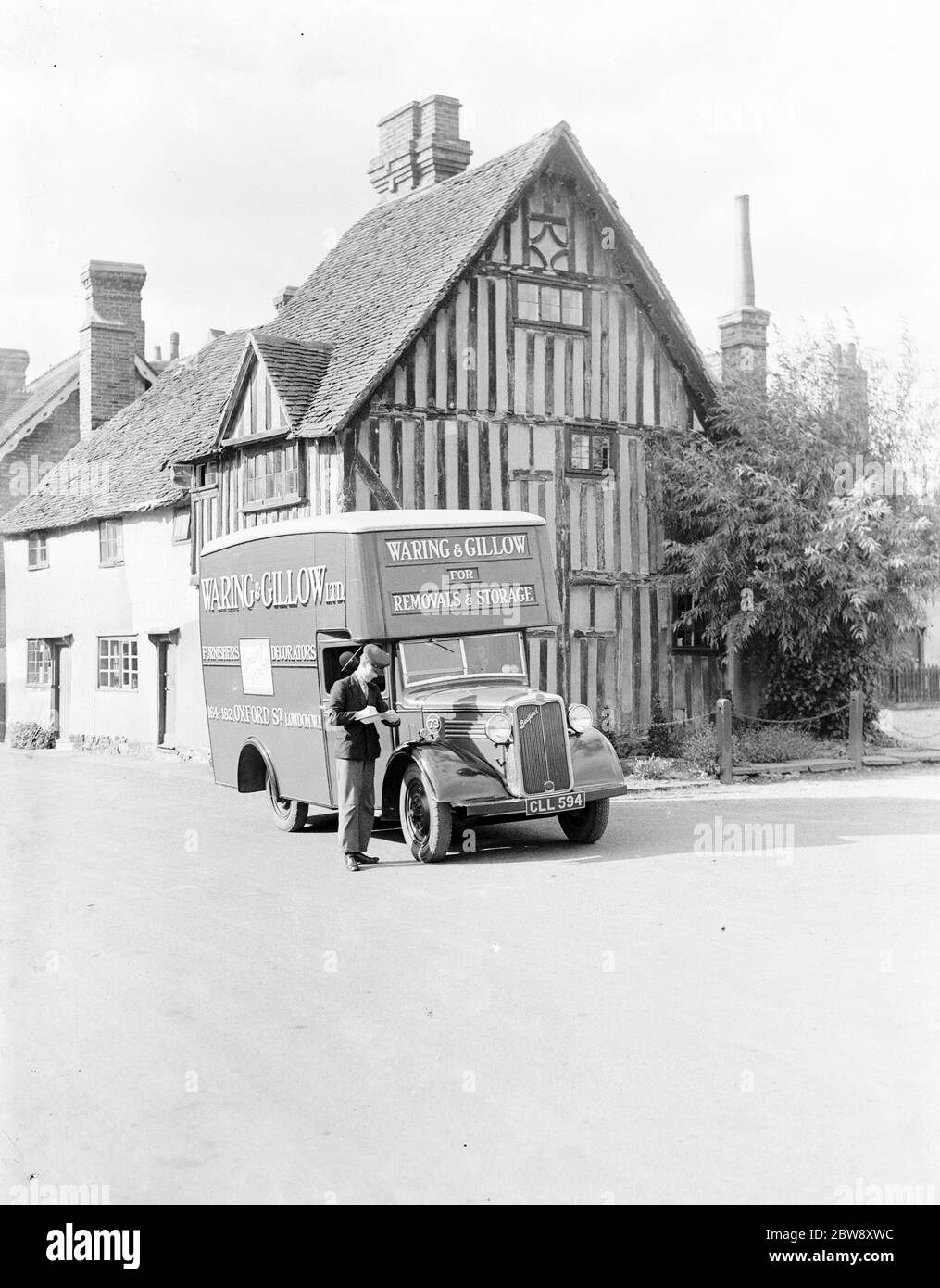 A Bedford truck belonging to Waring and Gillow Ltd , the storage and removal company , parked ouside a cottage . 1938 . Stock Photo