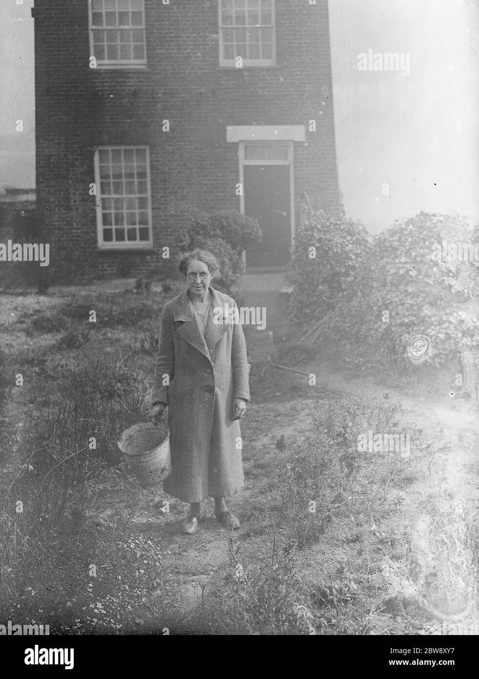 Mrs A Peck of Northfleet with her tin bucket . 7 March 1938 . Stock Photo