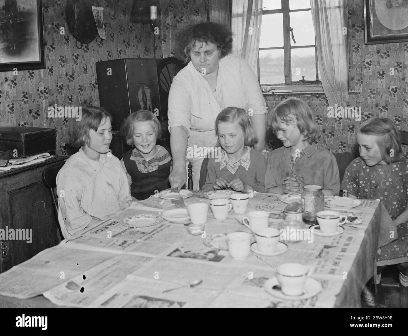 Mrs W E Wakefield with her daughters sitting by the dining table at their home in Gravesend , Kent . 1939 Stock Photo