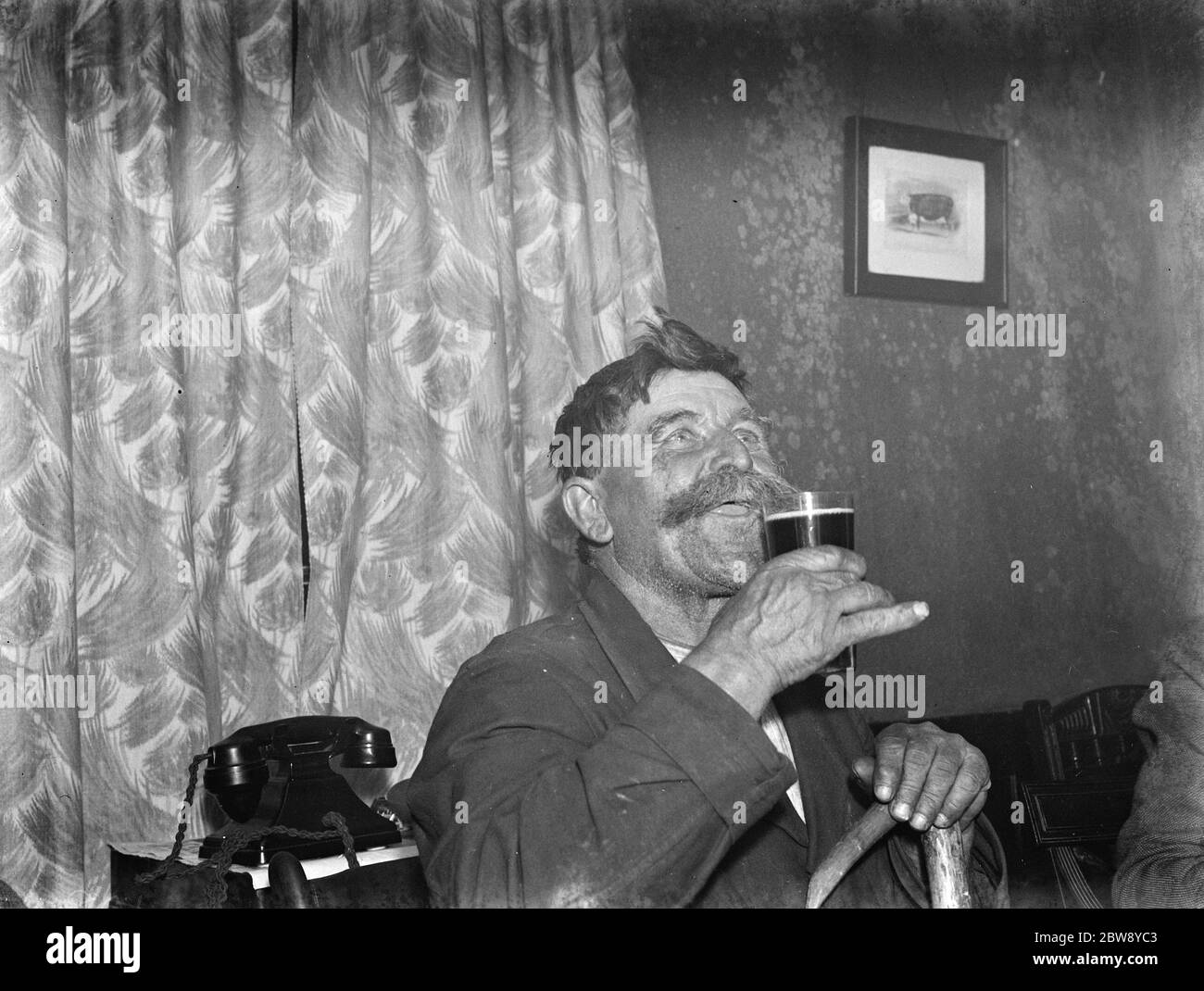 Paying in night at the Rat and Sparrow Club in Eynsford , Kent . Mr Charlie Meadows enjoying a pint of beer . 1939 Stock Photo