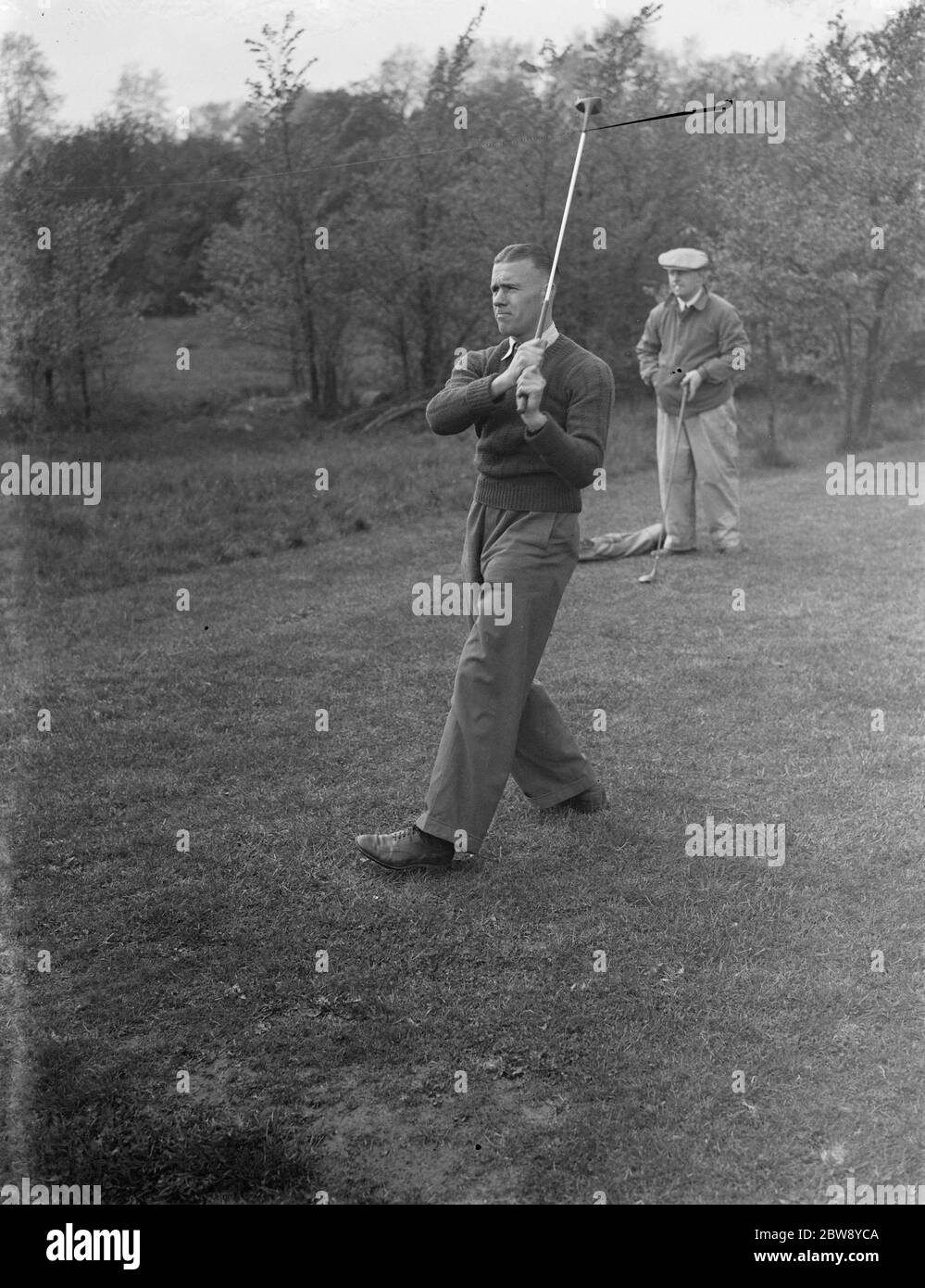 Millwall footballers enjoy a break from the pitch and relax on the Beckenham golf course . Jack Sykes drives the ball . 1939 Stock Photo