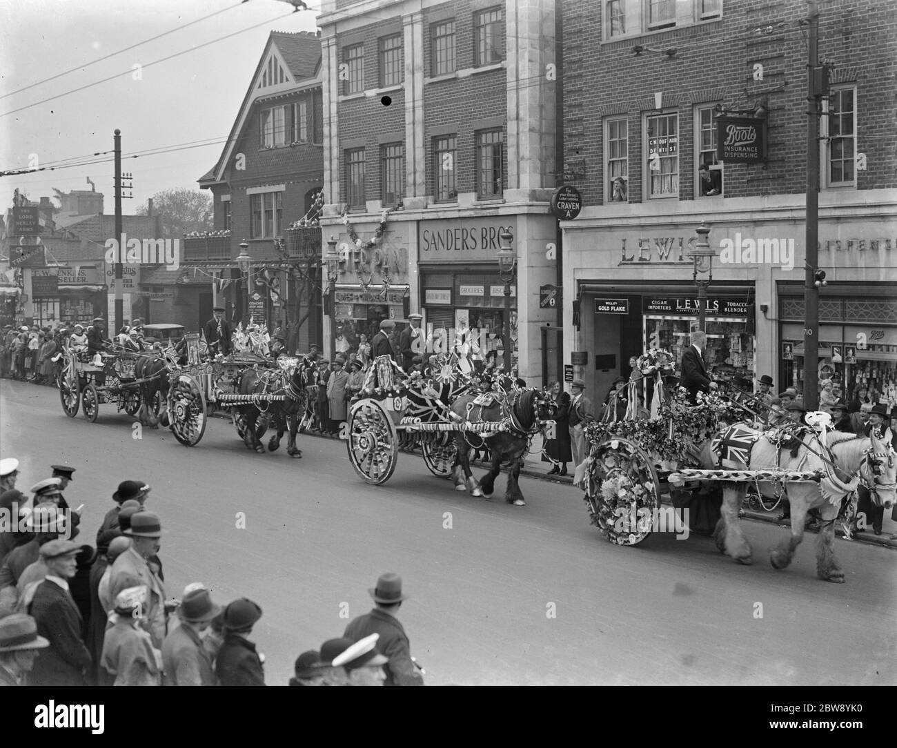 Coronation festivities in Bexleyheath , Kent , to celebrate the coronation of King George VI . Decorated horse and carriage bill parade through the streets . 15 May 1937 Stock Photo