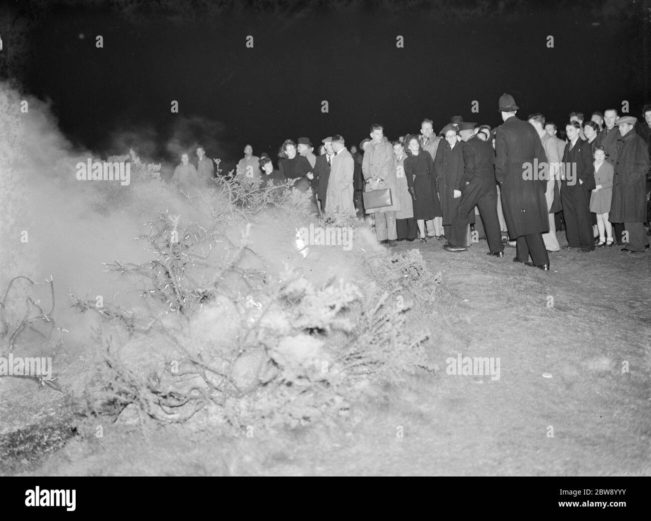 A crowd gathers at the site of a fire on Dartford Heath , Kent . 1939 Stock Photo