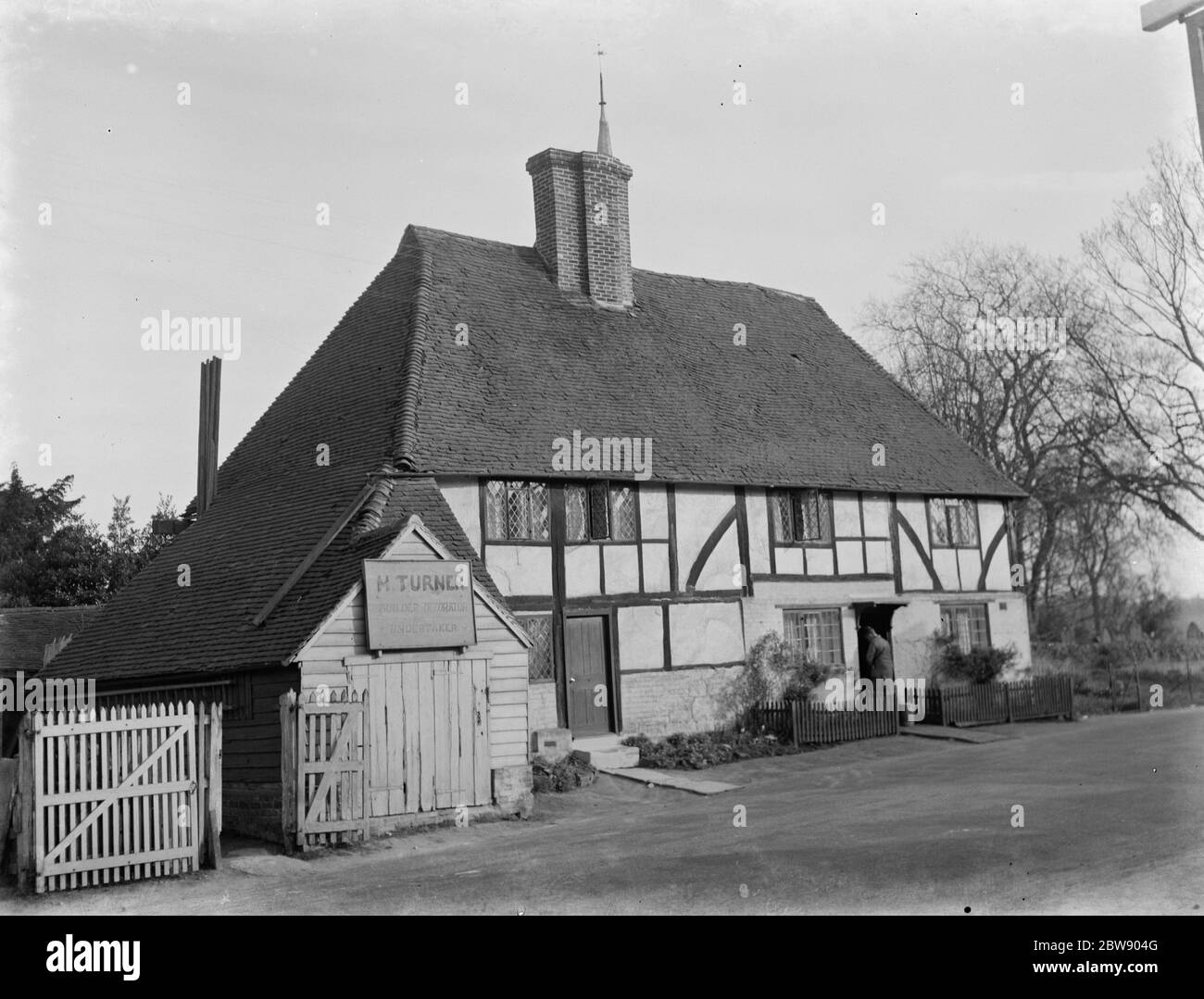 Old timber cottage in Cowden , Kent . It is the home of M Turner a local builder , painter and undertaker . 1937 Stock Photo